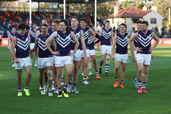 The Dockers celebrate as they walk from the field after victory during the round 23 match against the Greater Western Sydney Giants.