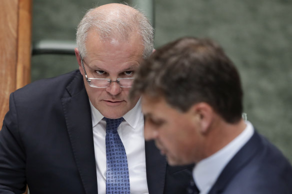 Prime Minister Scott Morrison listens as Minister for Energy Angus Taylor speaks during question time on Thursday.