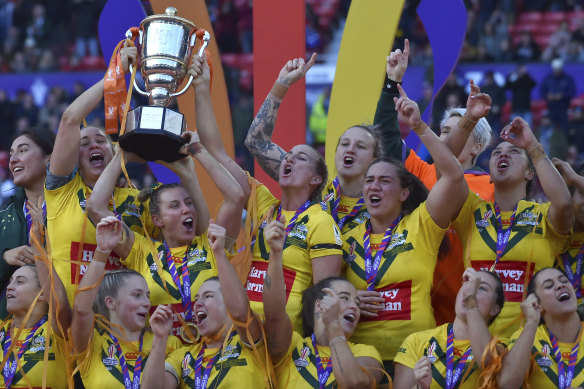 Australia’s players celebrate with the trophy after winning the World Cup.