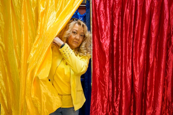 A woman exits a voting booth in Bucharest on Sunday.