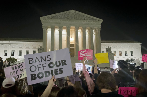 A crowd of people gather outside the Supreme Court in Washington after the draft decision was published in Politico.