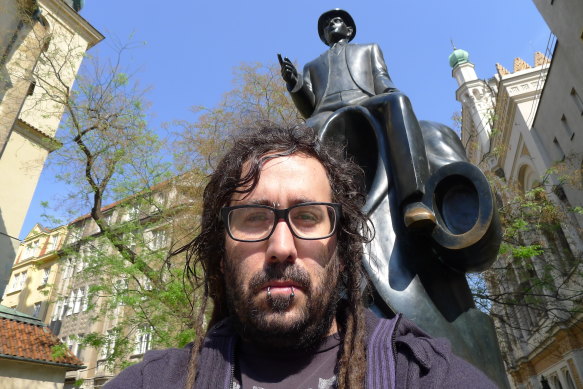Bram Presser in front of the Kafka statue in Prague. 