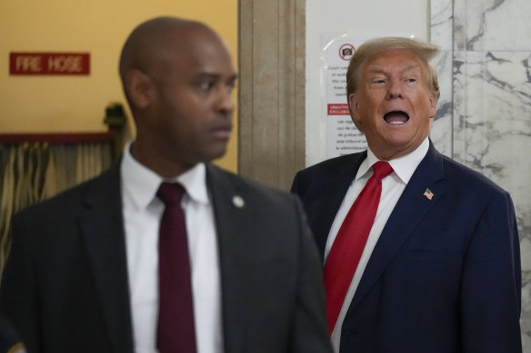 Former president Donald Trump stops to speak to the media during a break in his civil business fraud trial at New York Supreme Court.