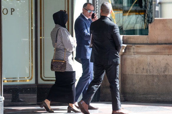 A lawyer for and supporters of the accused outside a Sydney court after an extradition hearing earlier this month.