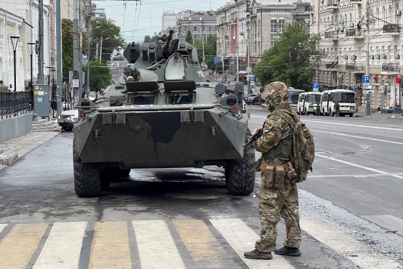 Fighters of Wagner private mercenary group stand guard in a street near military headquarters in the Russian city of Rostov-on-Don.