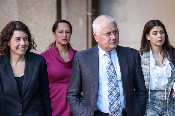 Bret Walker, SC, centre, arrives at the Federal Court on Friday.