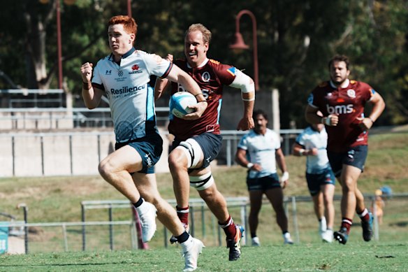 Sid Harvey races away from the Reds’ defence to score in a trial game on Saturday at Ballymore.
