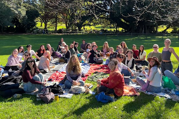 A group of people sitting on picnic blankets in the Royal Botanic Garden for a Community Craft Club Sydney meeting