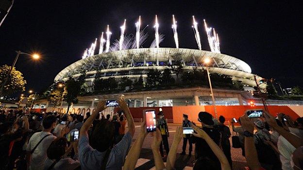 People gather outside the Tokyo National Stadium to participate in the Games closing ceremony from anyway they could, given spectators were not allowed in due to the pandemic.