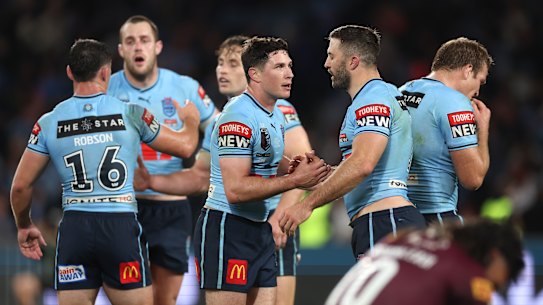 Mitchell Moses and James Tedesco celebrate.