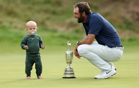 Scottie Scheffler of the United States celebrates with his son Bennett Scheffler and the Claret Jug on the 18th green after winning The 153rd Open Championship at Royal Portrush Golf Club on July 20, 2025 in Portrush, Northern Ireland.