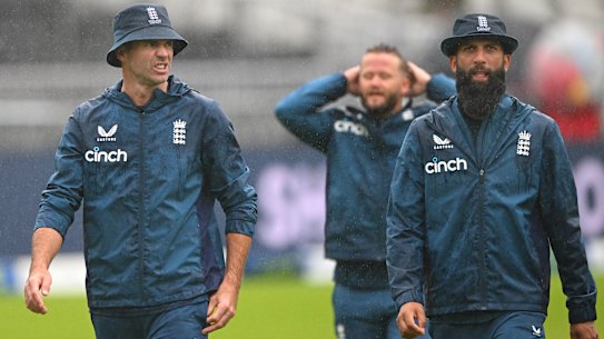 England players look downcast as the rain continued to fall.