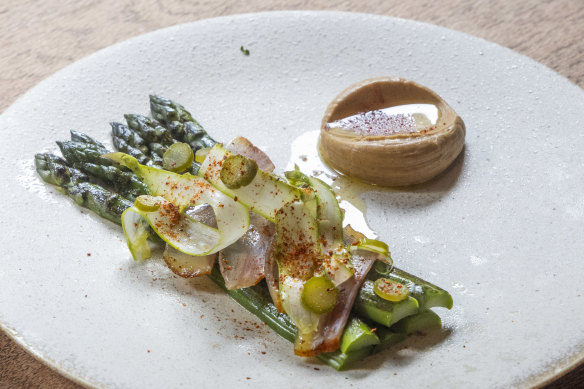 New-season asparagus, prepared three ways, is served with guanciale (cured pork cheek) and comte custard.
