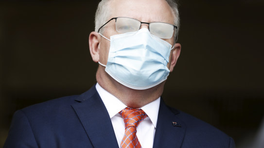Prime Minister Scott Morrison, seen here with fogged glasses from wearing a mask, has flagged more funding will come for aged care.
