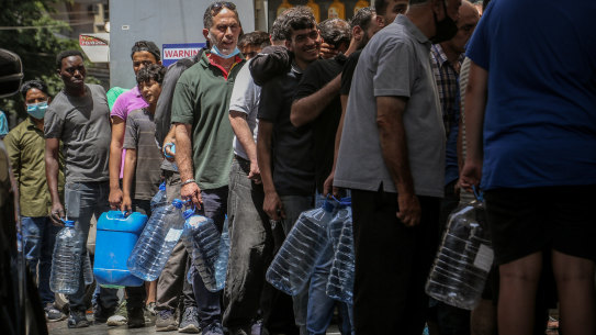 People wait in line at a petrol station in Beirut amid fuel shortages. 