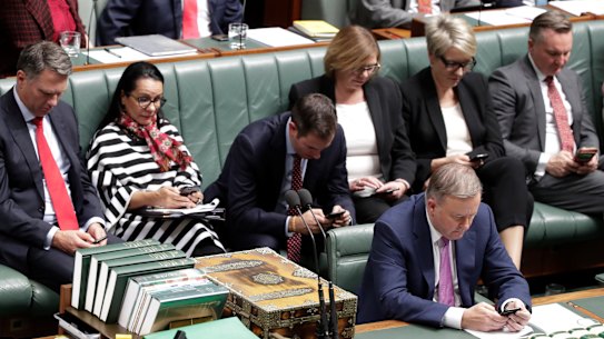 Top Labor frontbenchers on their mobile phones during question time on Monday.