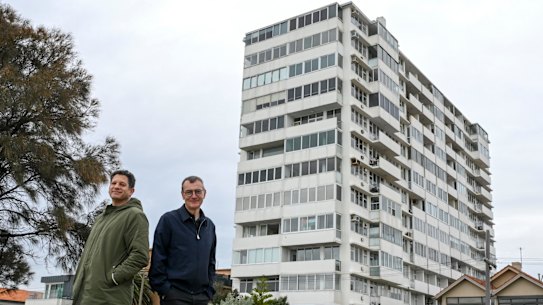 Architect Rowan Opat (left) and home owner Russell Jessop stand in front of the 64-year-old Edgewater Towers in St Kilda.
