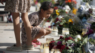 A child looks at a memorial site for the victims killed in this week’s shooting at Robb Elementary School.