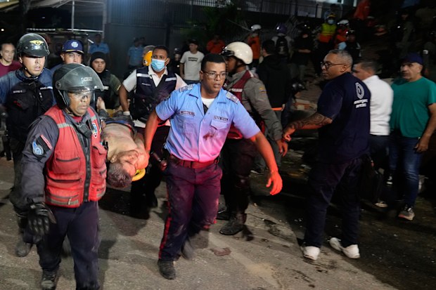 Rescue worker carry an injured man after an earthquake in Caracas, Venezuela, Wednesday, June 24, 2026.