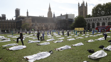 Demonstrators lie under sheets in a Extinction Rebellion "die in" protest in London in September. They were urging MPs to pass a further climate emergency bill to prepare for a climate crisis.