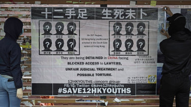 University students put up posters to demand the release 12 Hong Kong activists detained at sea by Chinese authorities at a "Lennon wall" in the University of Hong Kong. 