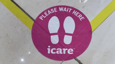 A sticker on the floor in the foyer of icare's building in Sydney. 