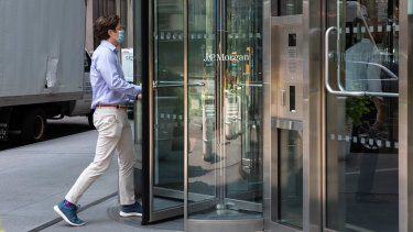 An office worker goes to work at JP Morgan in Wall Streetâs new dress code - chinos and sneakers.