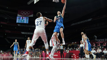 Slovenia’s Jaka Blazic (11) drives to the basket over France’s Rudy Gobert (27).