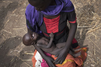 Adel Bol, 20, cradles her 10-month-old daughter Akir Mayen at a food distribution site in Malualkuel, South Sudan in 2017. The country may be closer than any other to famine after five years of civil war.