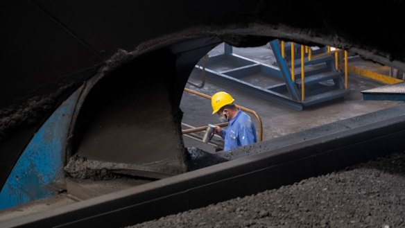 A worker monitors the coal dumping process at the Caofeidian Port in Hebei Province. 