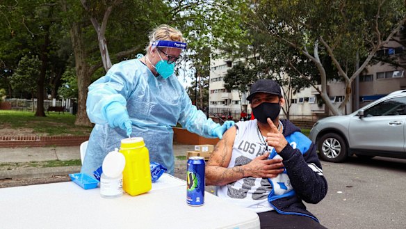 A man receives a Pfizer vaccine for COVID-19 at Waterloo in Sydney this week.