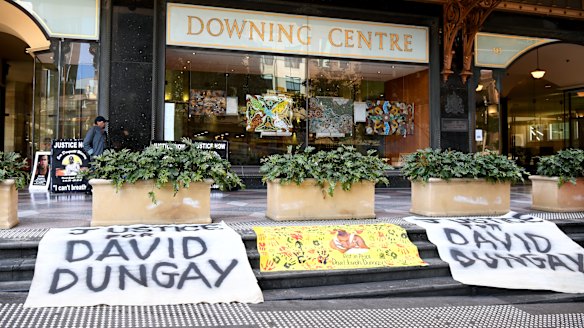 Banners reading "Justice for David Dungay" outside the Downing Centre Court in Sydney on Monday. 