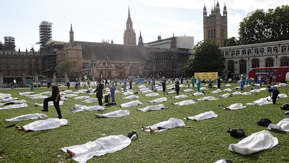 Demonstrators lie under sheets in a Extinction Rebellion "die in" protest in London in September. They were urging MPs to pass a further climate emergency bill to prepare for a climate crisis.