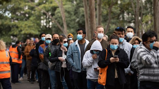 Hundreds of people wait to receive their COVID-19 vaccination at Homebush on Saturday.