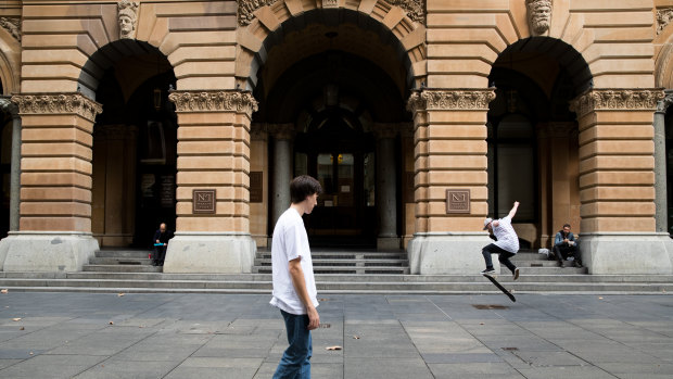 Skateboarders take advantage of a quiet Martin Place in Sydney's CBD during lunchtime. 