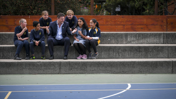 Principal Rob Duncan with a group of Year Five students whose results have markedly improved.