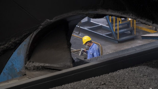 A worker monitors the coal dumping process at the Caofeidian Port in Hebei Province. 