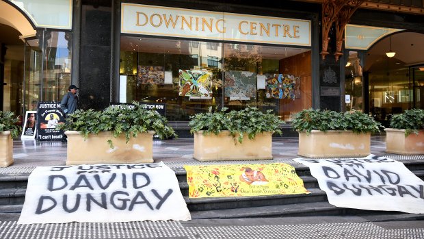 Banners reading "Justice for David Dungay" outside the Downing Centre Court in Sydney on Monday. 