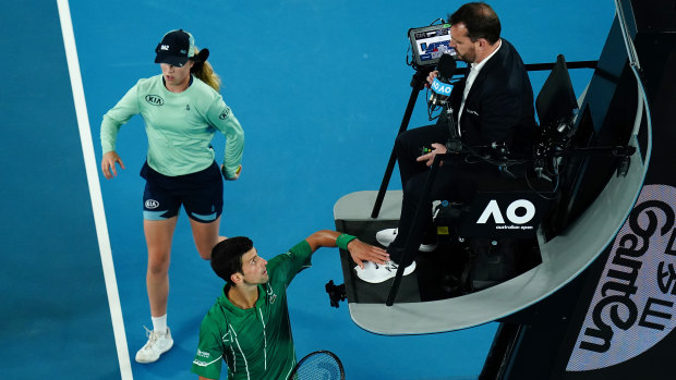 Novak Djokovic taps the chair umpire's foot during the Australian Open final.