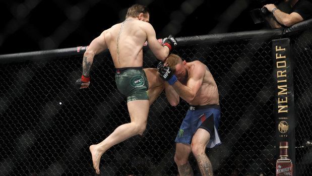 Ducking for cover: Donald Cerrone on the defensive as Conor McGregor launches into an attack.