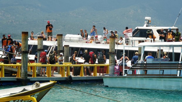 A speedboat drops and picks up tourists at Gili Air harbour. 