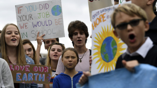 Greta Thunberg, centre in blue, joins other young climate activists Friday for a climate strike outside the White House in Washington on Friday.