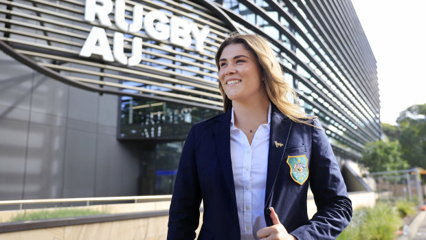 Piper Duck stands in front of the Rugby Australia building.