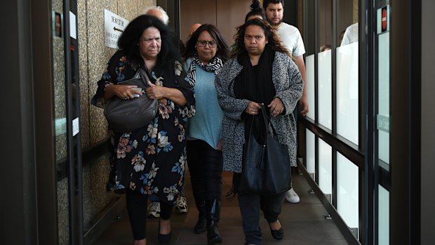 Family and supporters of the victims leave court. 