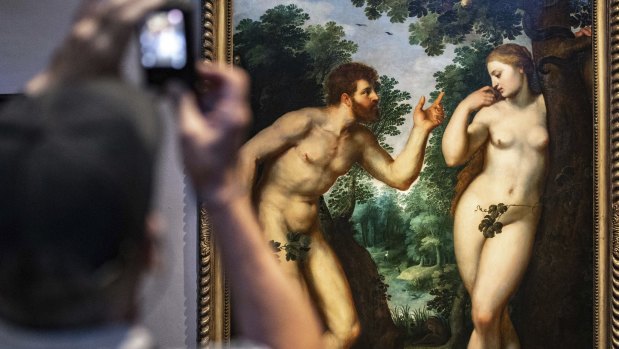 Visitors look at the painting "Adam and Eve" by Flemish master Peter Paul Rubens in the Rubenshouse in Antwerp, Belgium. 