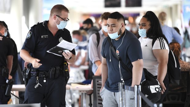 Incoming passengers are screened by police as they arrive at the domestic terminal at Brisbane Airport.