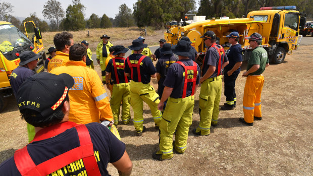 Rural firefighters are seen preparing to fight fires at Spicers Gap, south west of Brisbane, on Wednesday.