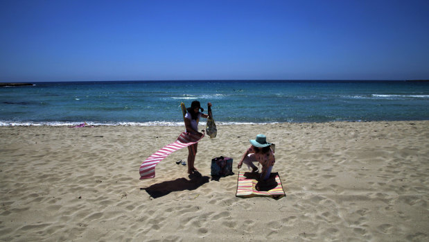 Sunbathers enjoy an empty stretch of Landa beach at the popular Cyprus seaside resort of Ayia Napa, a favourite among tourists from Europe and beyond.