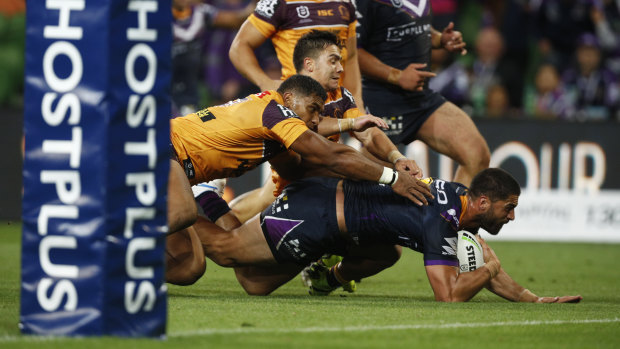 Jesse Bromwich dives for the try against the Broncos in Storm's season-opening win.