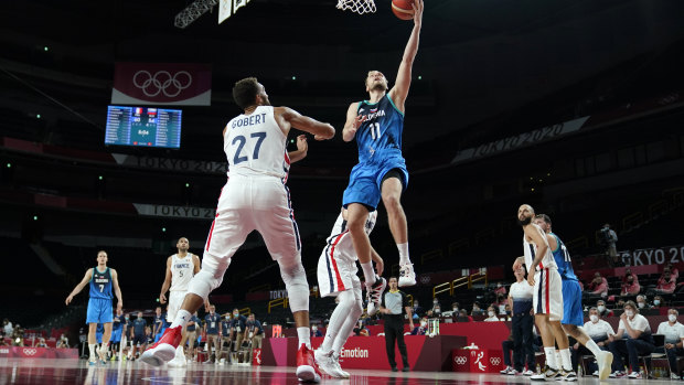 Slovenia’s Jaka Blazic (11) drives to the basket over France’s Rudy Gobert (27).